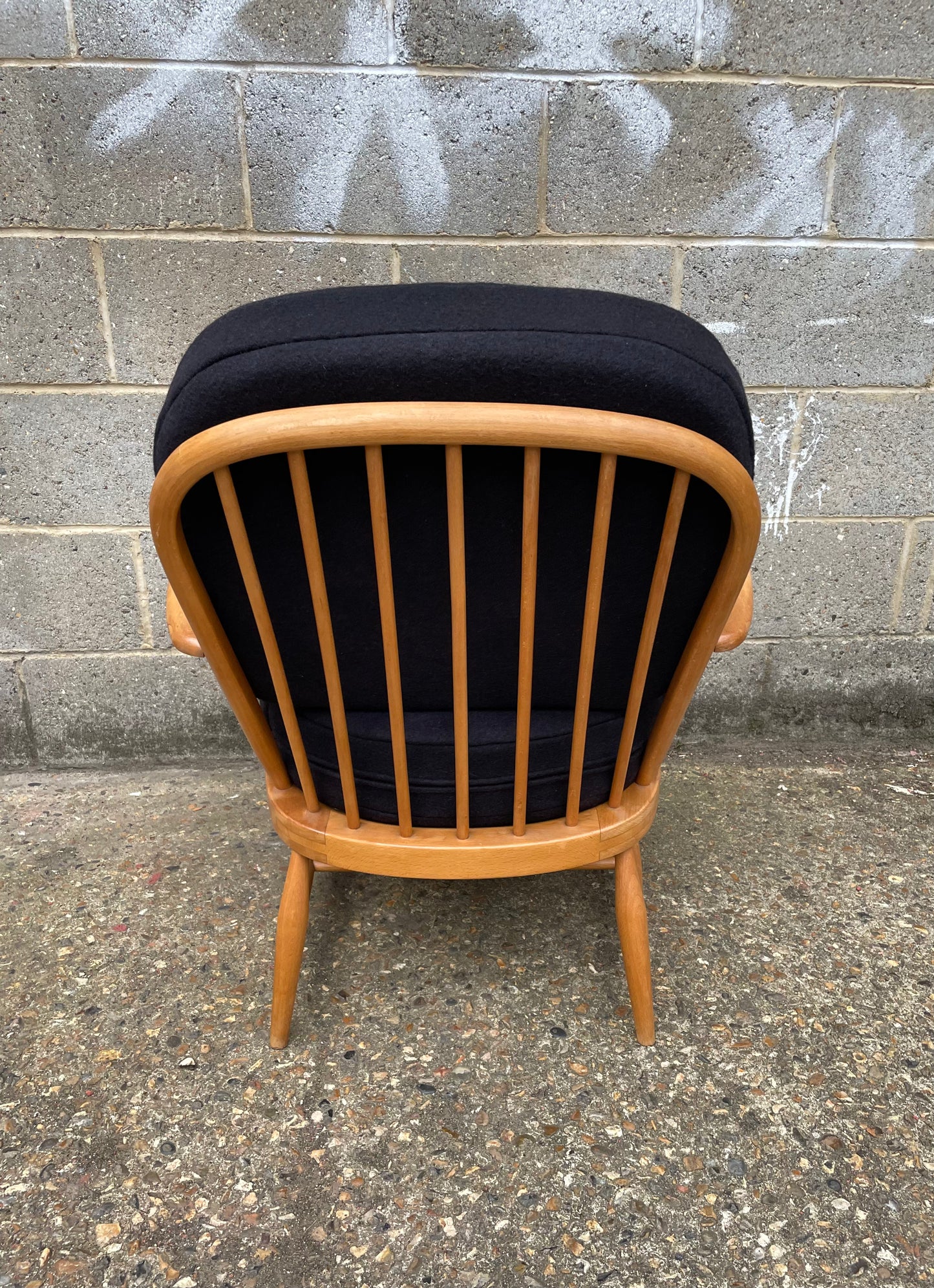 Ercol Windsor 334 armchair with dark dark grey cushion covers, wooden spindles on back of chair 