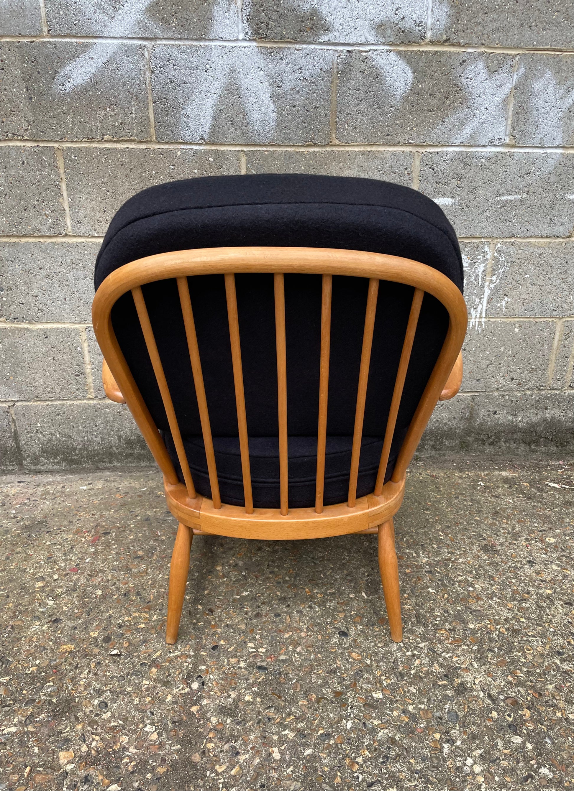 Ercol Windsor 334 armchair with dark dark grey cushion covers, wooden spindles on back of chair 